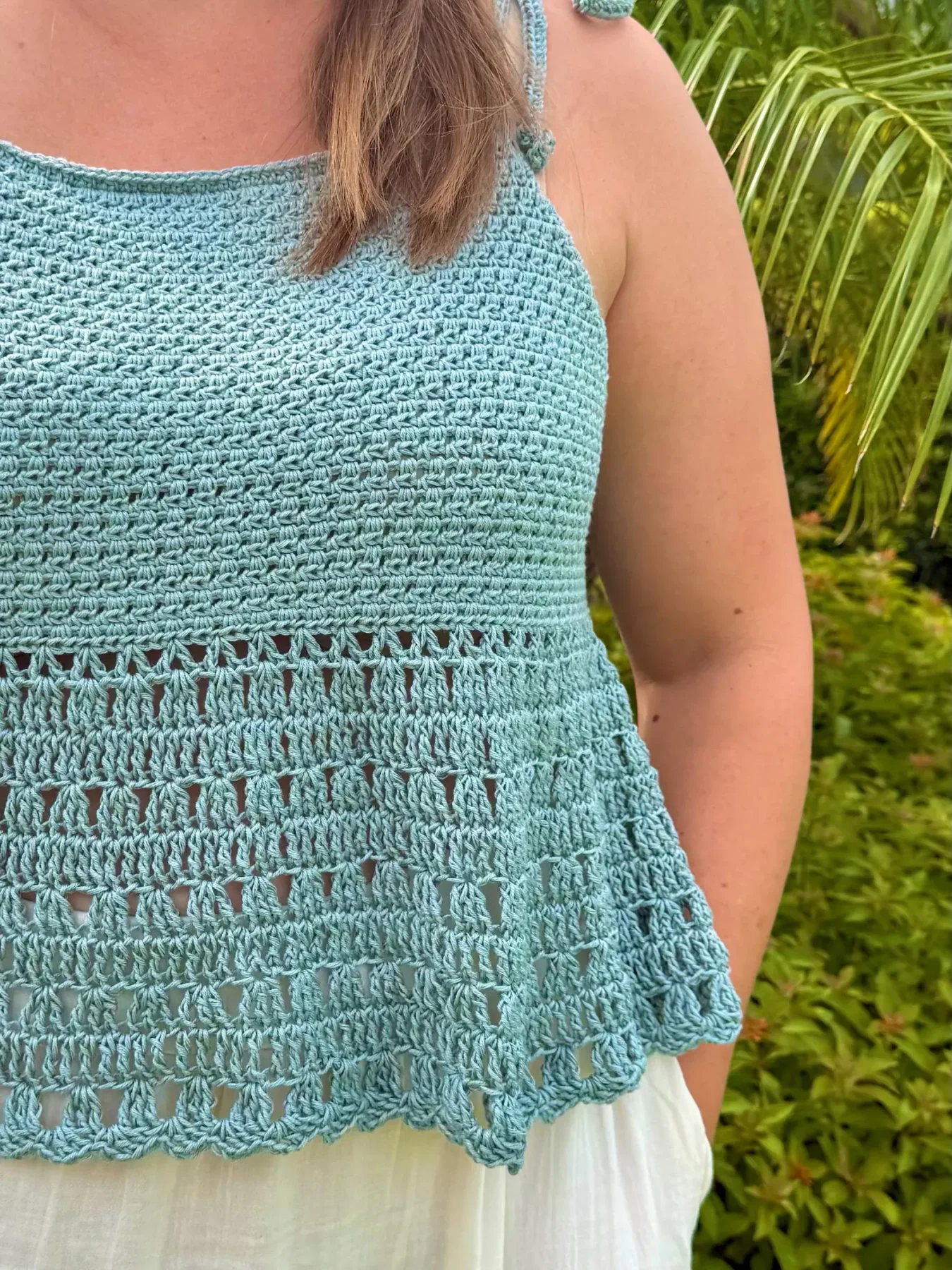 Blue Solara women's tank showing the bodice and openwork hem